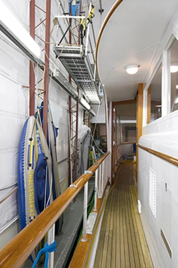 a long hallway with several ladders aboard EXCALIBUR Yacht for Sale