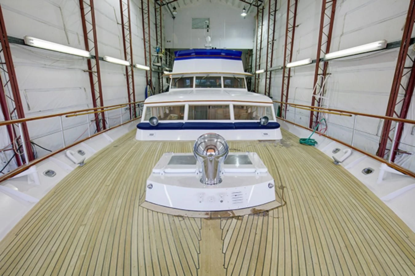 a white and blue boat in a large room aboard EXCALIBUR Yacht for Sale