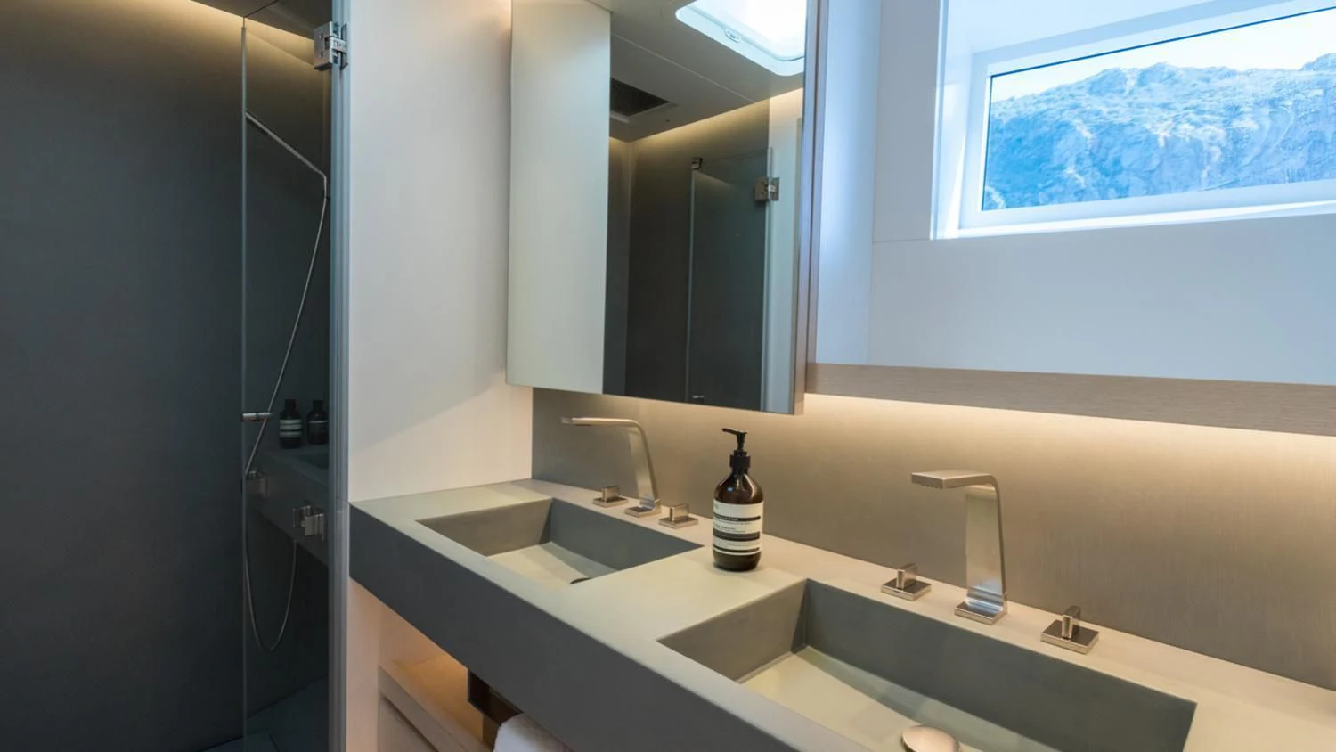 a bathroom with a countertop sink and a mirror aboard CERVO Yacht for Sale