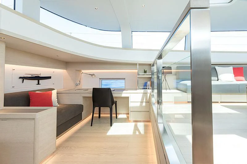 a room with a glass wall and a couch and a table aboard CERVO Yacht for Sale