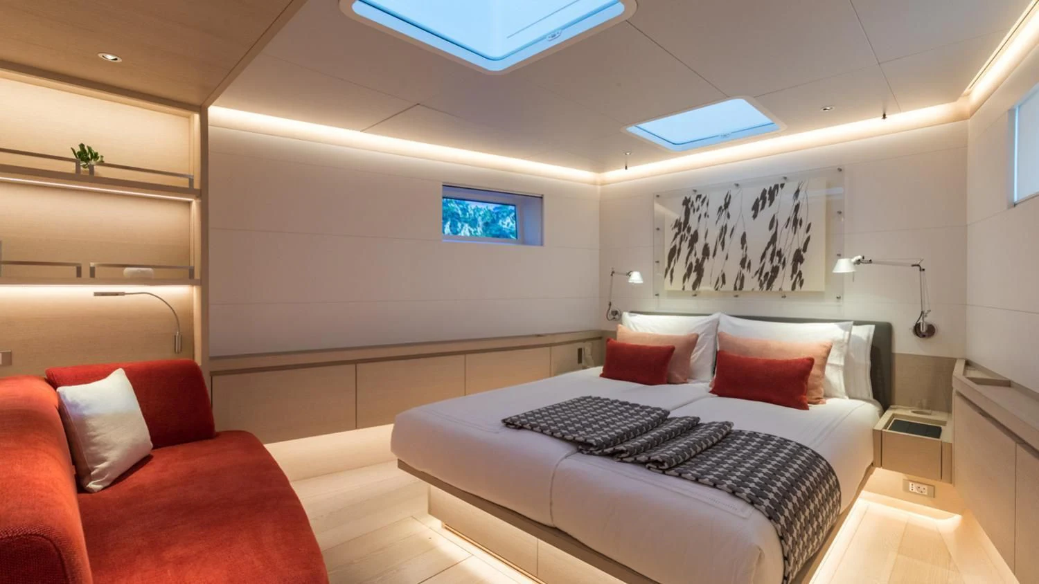 a room with a bed and a couch aboard CERVO Yacht for Sale