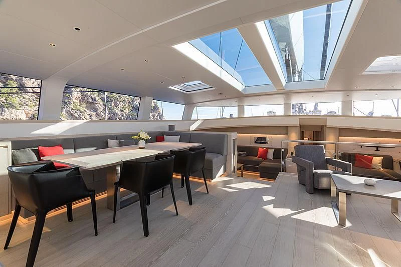 a room with a table and chairs aboard CERVO Yacht for Sale