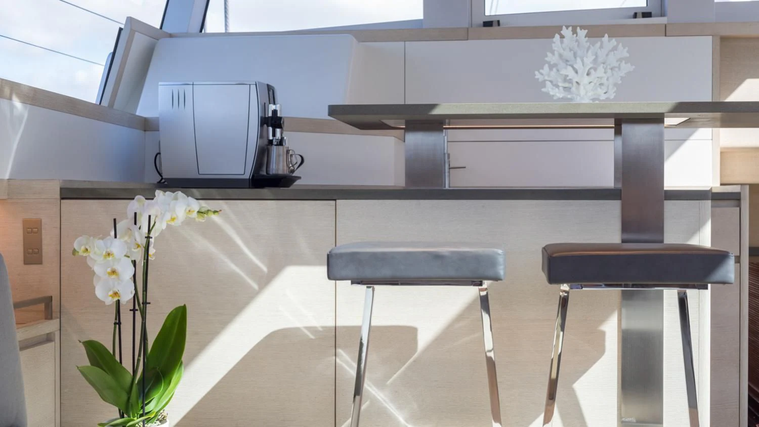 a table with a chair and a plant on it aboard CERVO Yacht for Sale