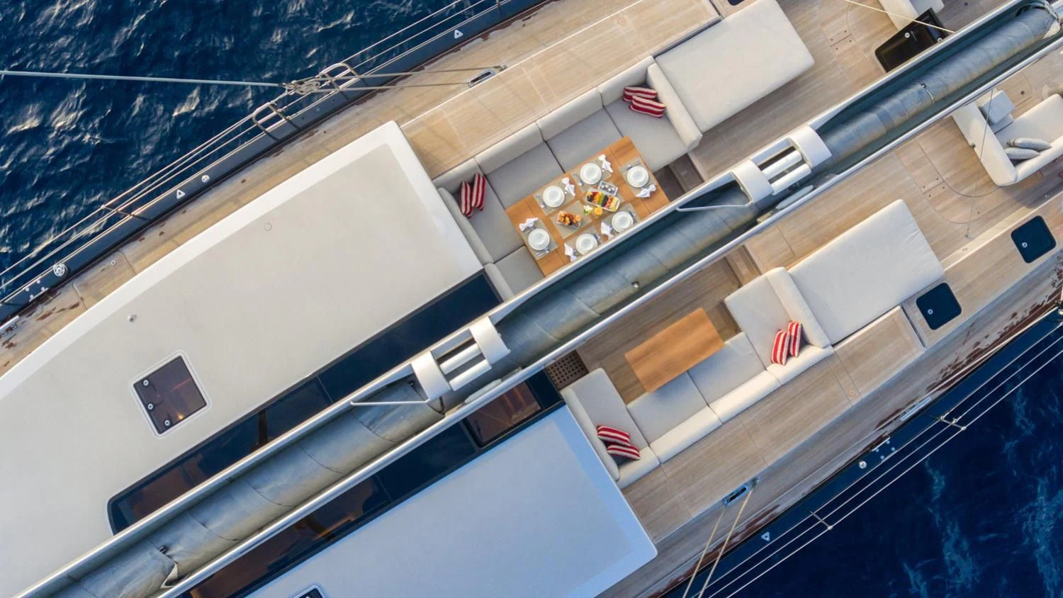 a large kitchen with a lot of countertop and chairs aboard CERVO Yacht for Sale