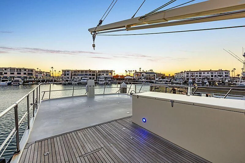 a dock with a body of water and buildings in the background aboard HOLIDAY Yacht for Sale
