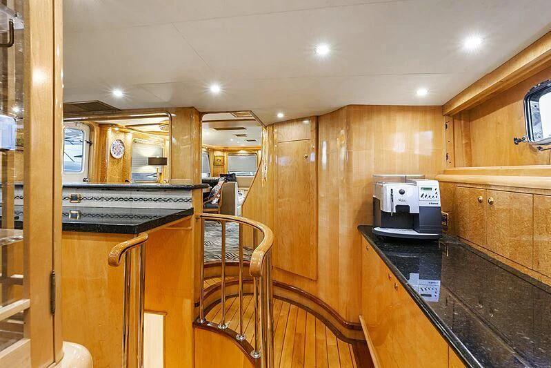 a kitchen with wooden cabinets aboard HOLIDAY Yacht for Sale
