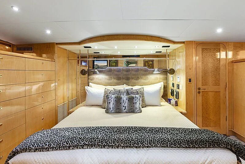 a bed with a mirror above it aboard HOLIDAY Yacht for Sale