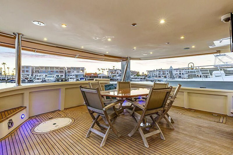 a room with tables and chairs aboard HOLIDAY Yacht for Sale