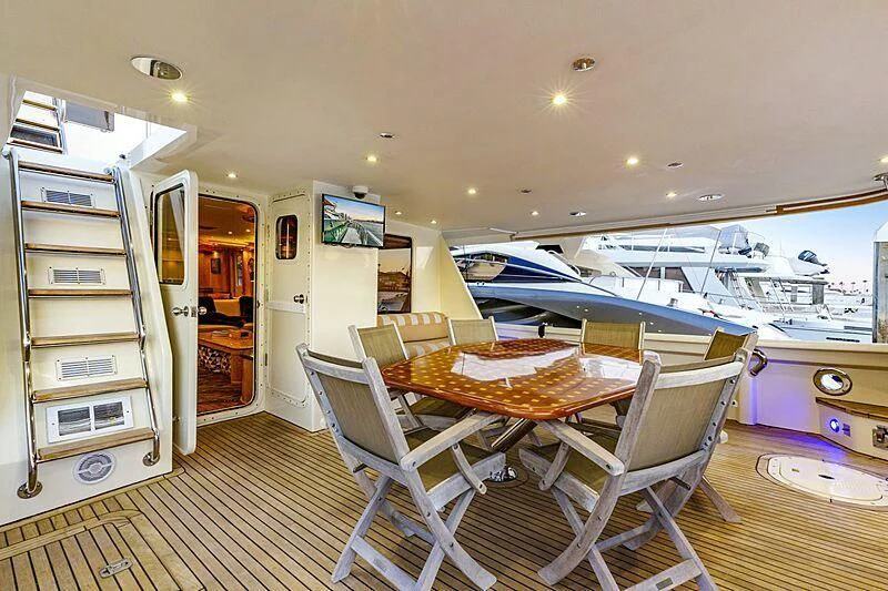 a room with a table and chairs aboard HOLIDAY Yacht for Sale