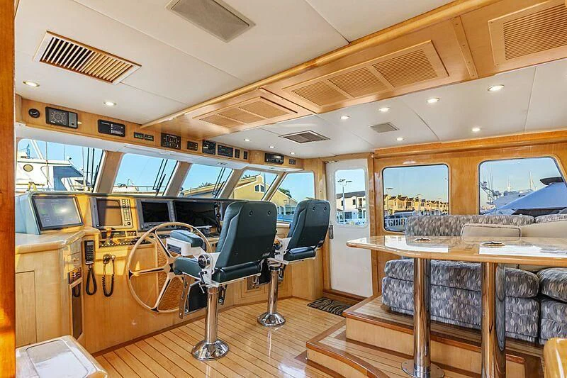 a room with a table and chairs aboard HOLIDAY Yacht for Sale