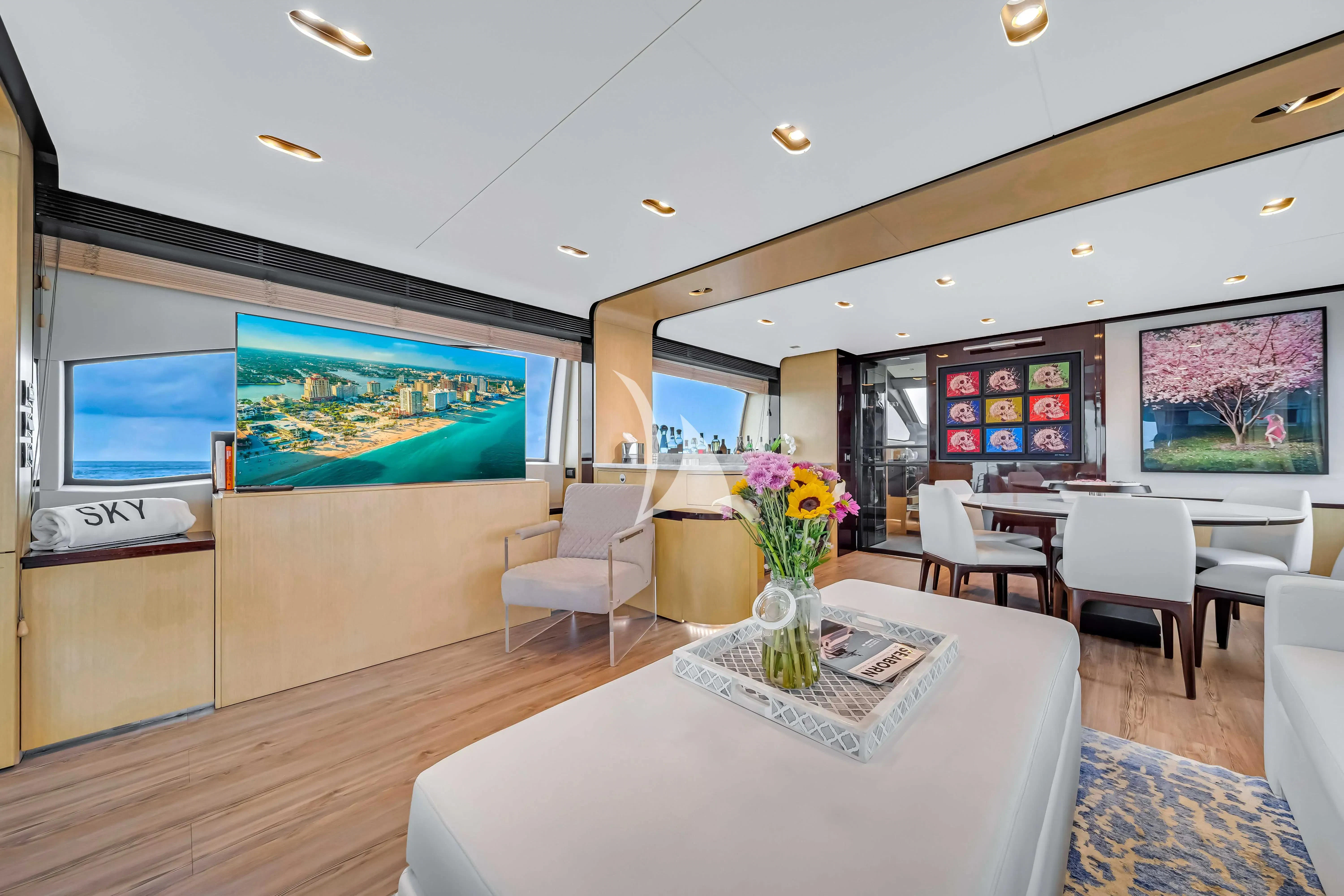 a room with a table and chairs aboard SKY Yacht for Sale