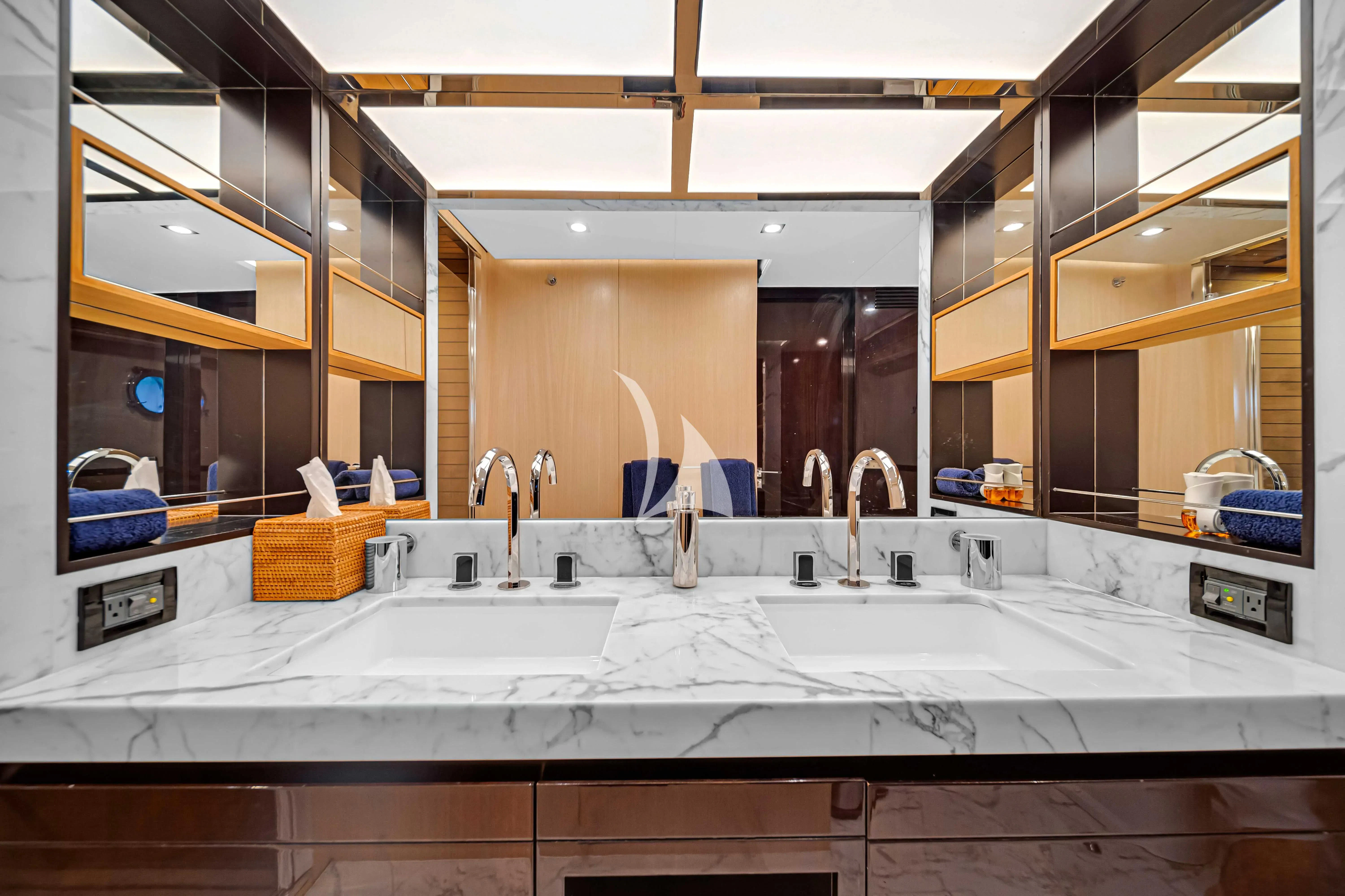 a bathroom with sinks and mirrors aboard SKY Yacht for Sale