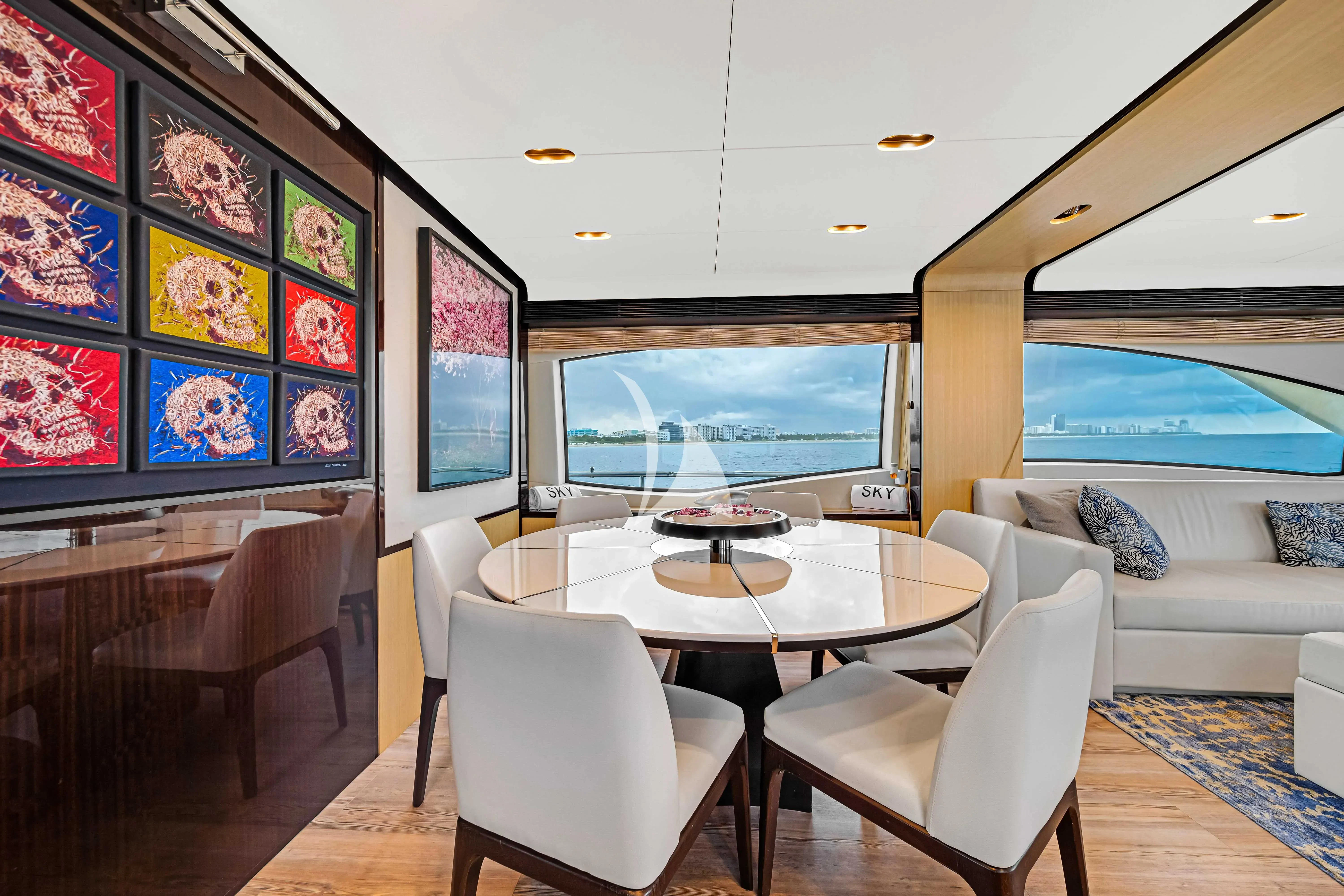 a room with a table and chairs aboard SKY Yacht for Sale