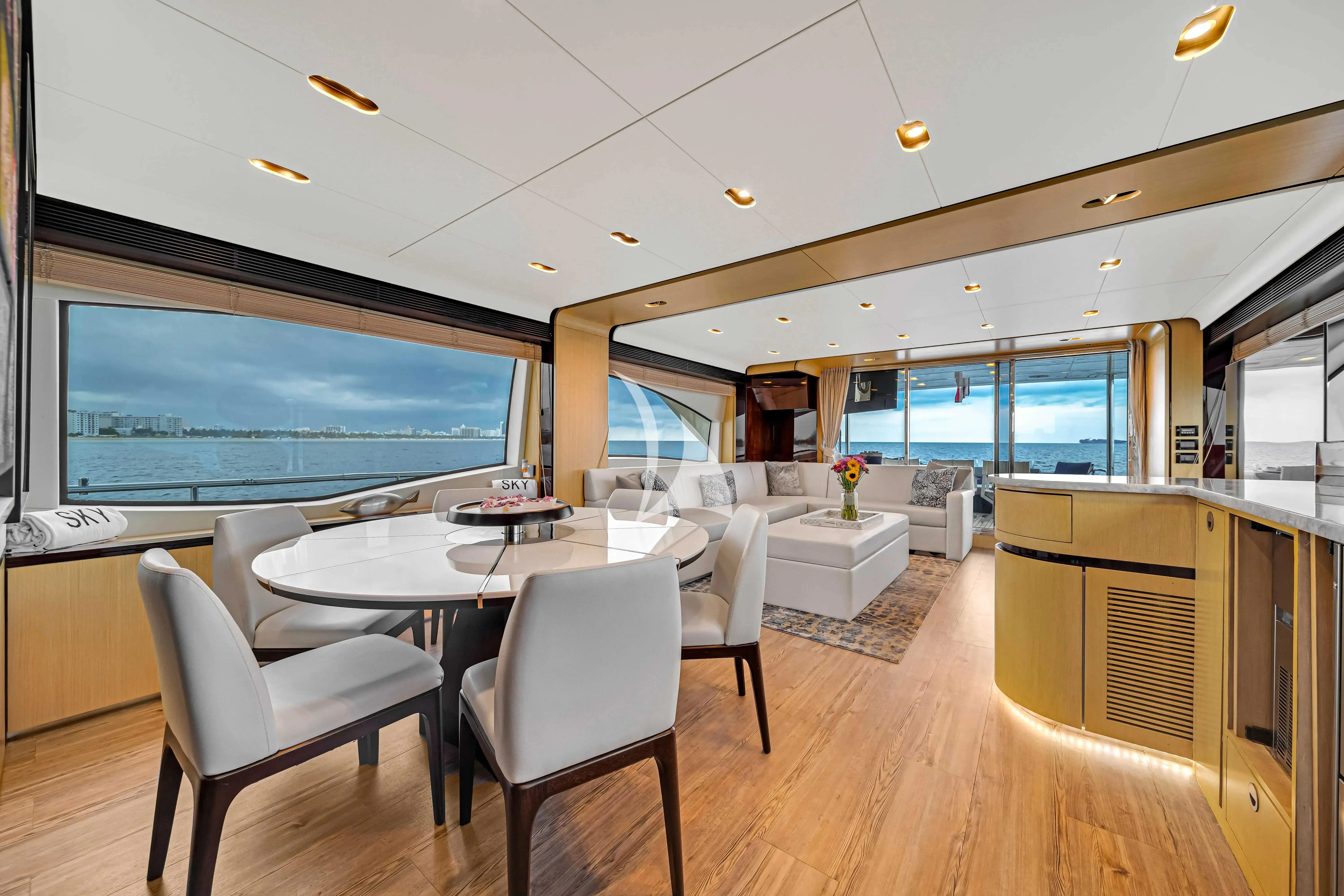 a room with a table and chairs aboard SKY Yacht for Sale