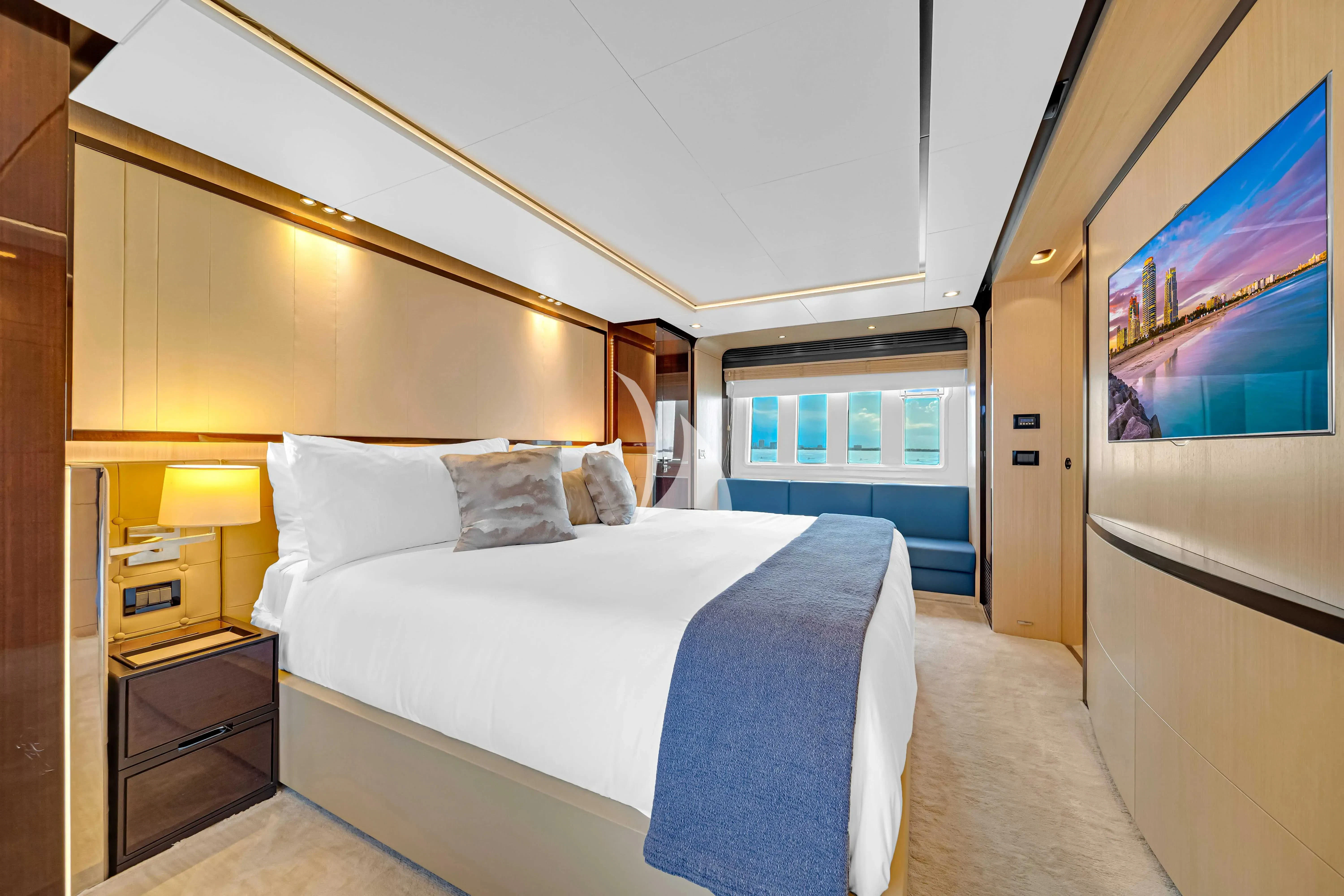 a bedroom with a bed and a desk aboard SKY Yacht for Sale