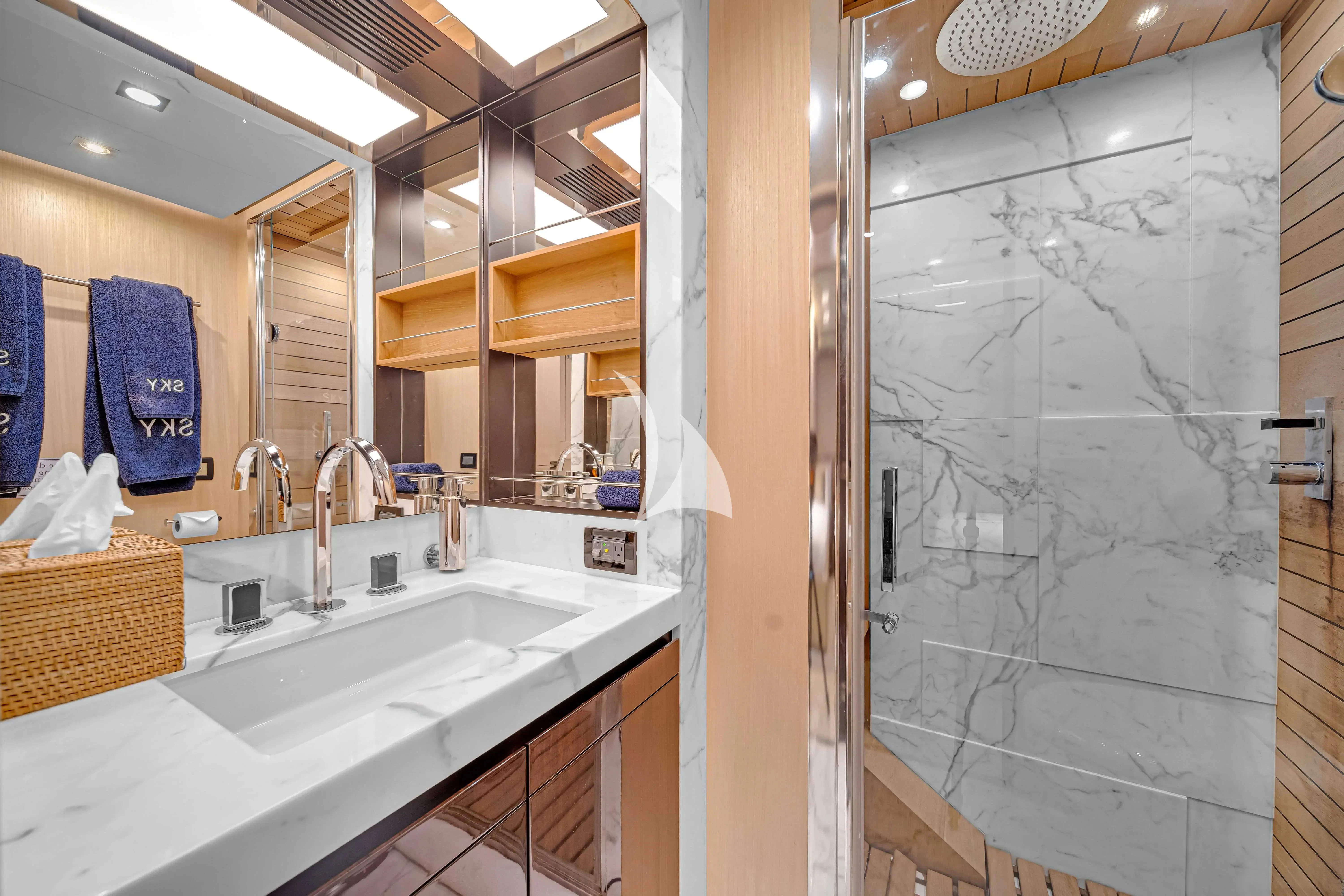 a bathroom with a large mirror aboard SKY Yacht for Sale