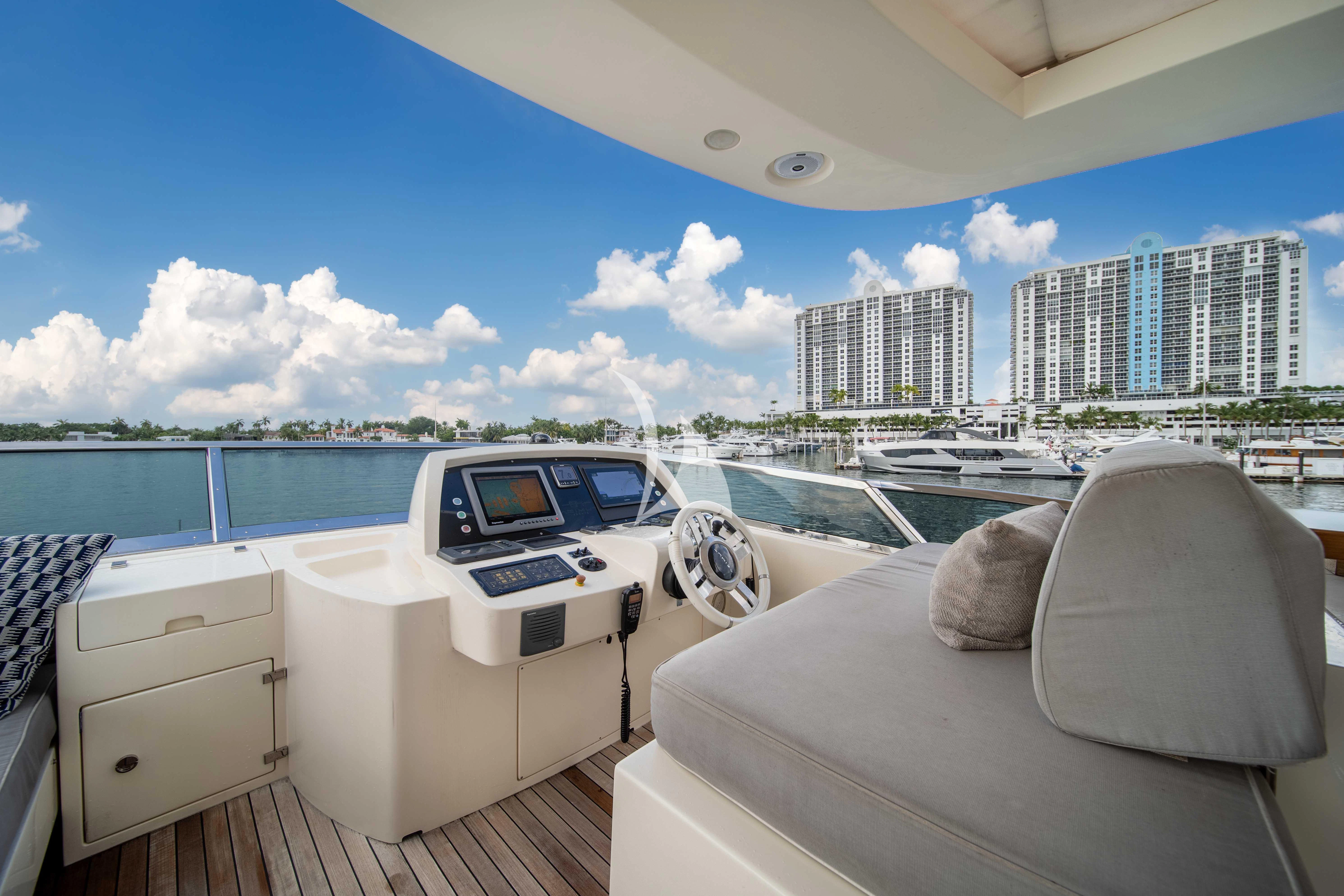 a room with a bed and a chair and a large body of water aboard SKY Yacht for Sale