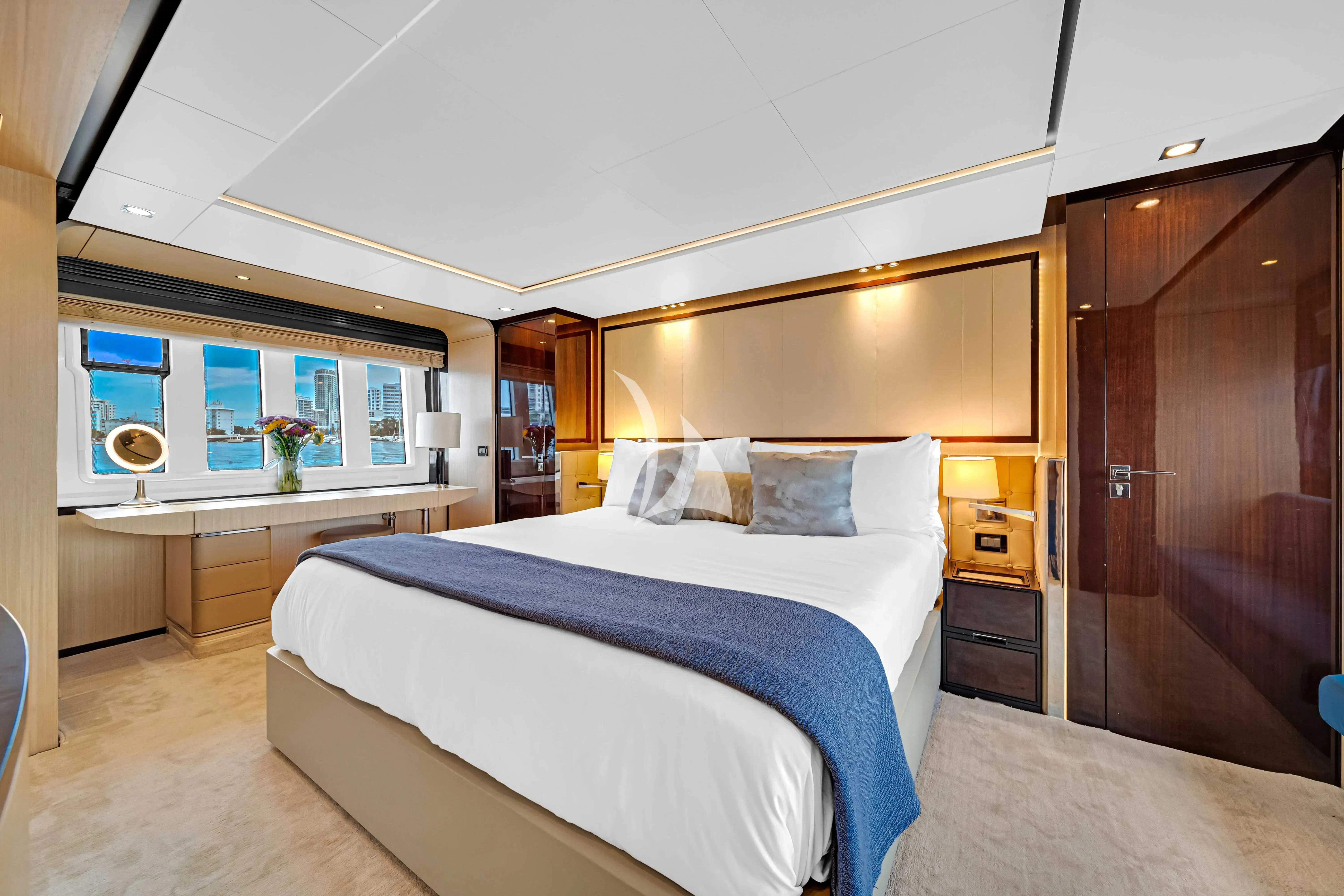 a bedroom with a bed and a desk aboard SKY Yacht for Sale