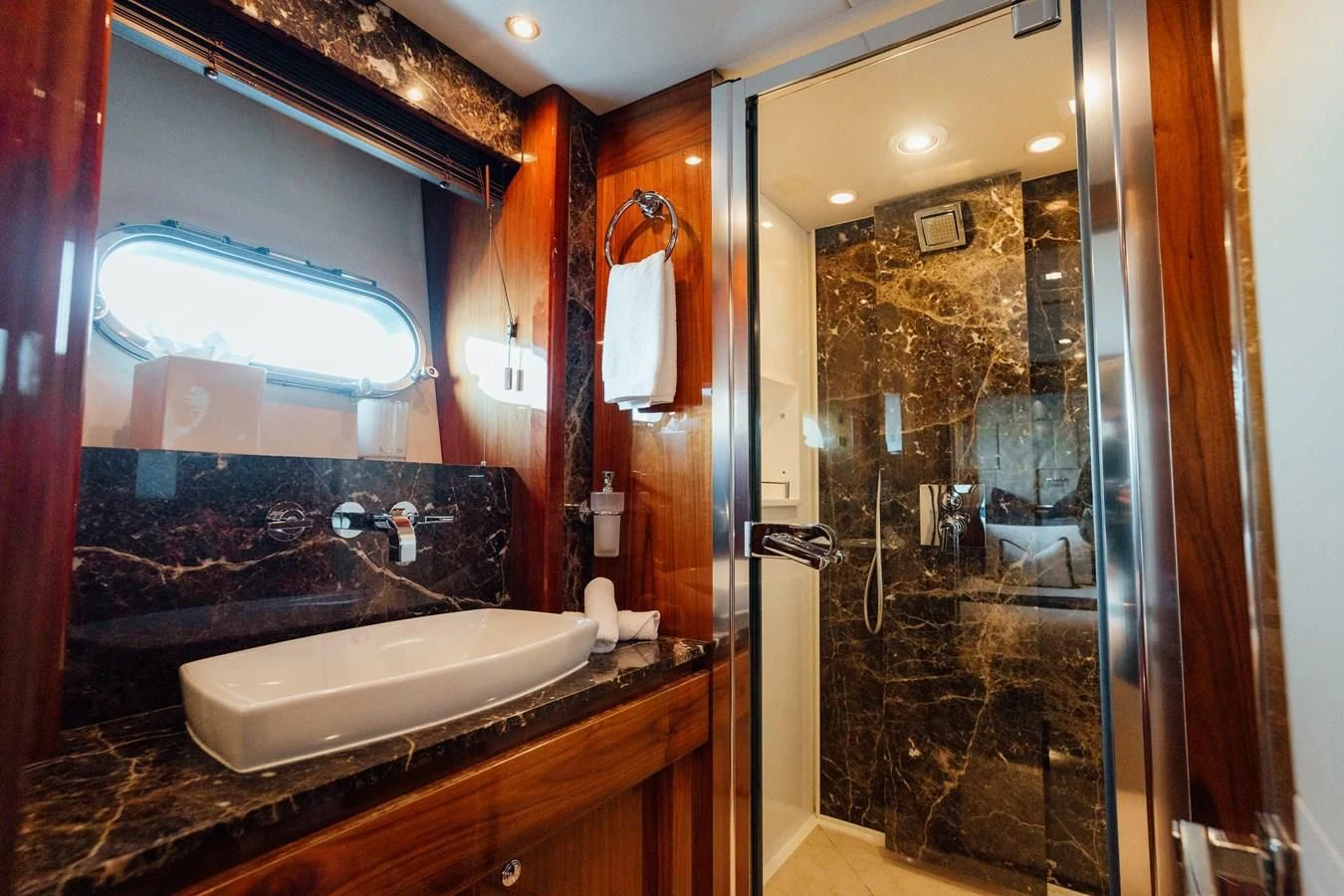 a bathroom with a large mirror aboard CHAOS Yacht for Sale