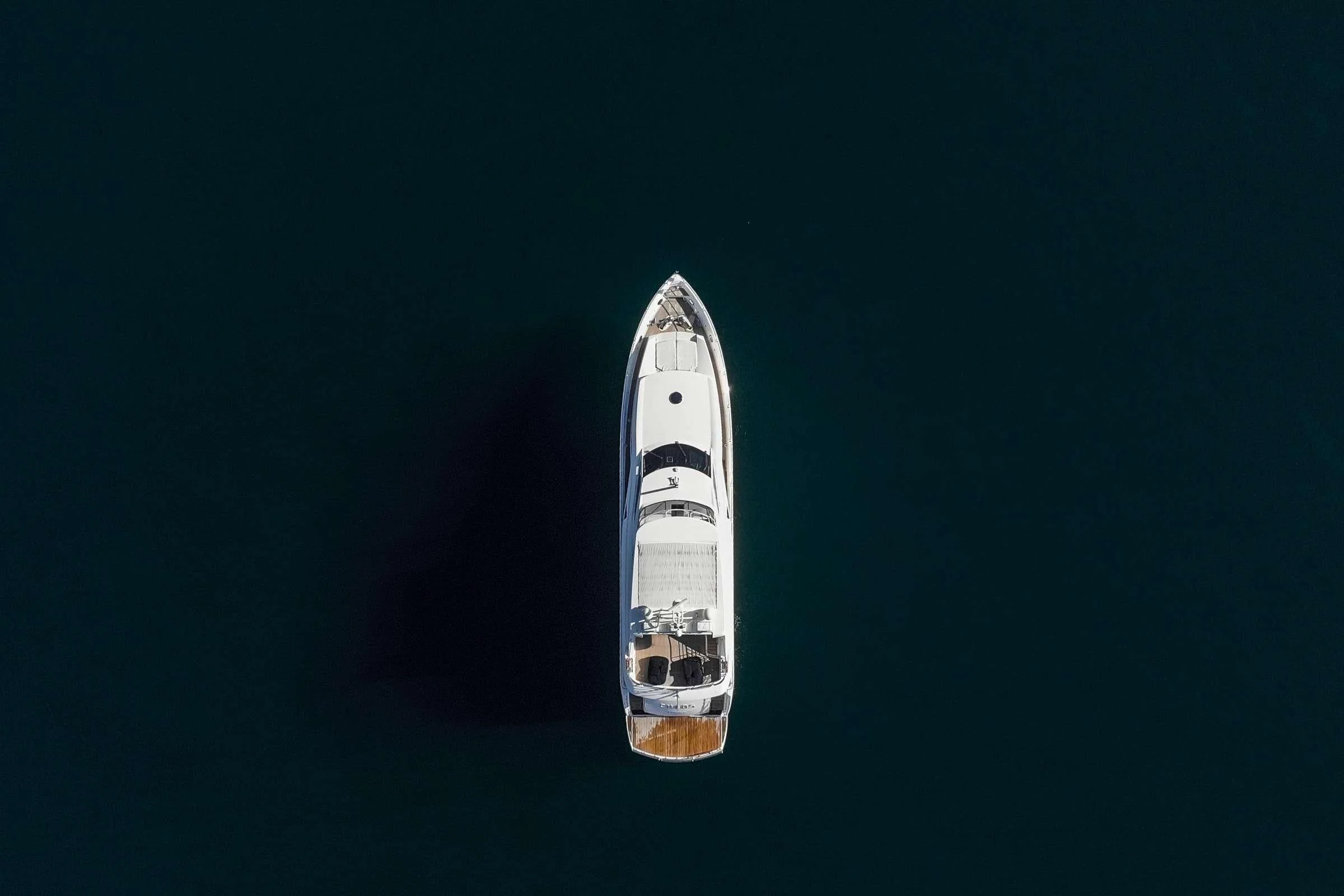 a white boat on water aboard CHAOS Yacht for Sale