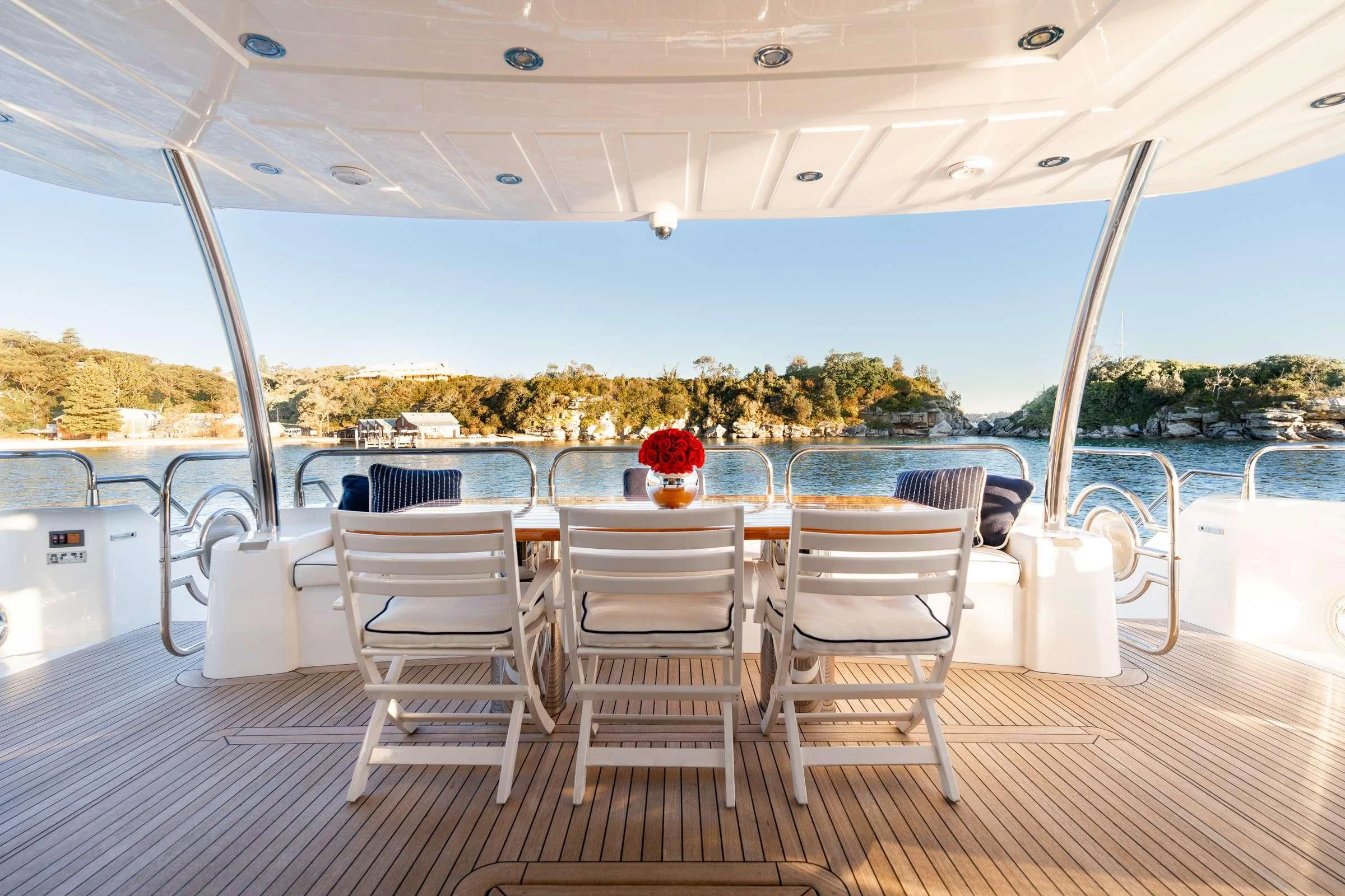 a table and chairs on a deck aboard CHAOS Yacht for Sale
