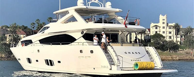 a white boat with people on it aboard CHAOS Yacht for Sale