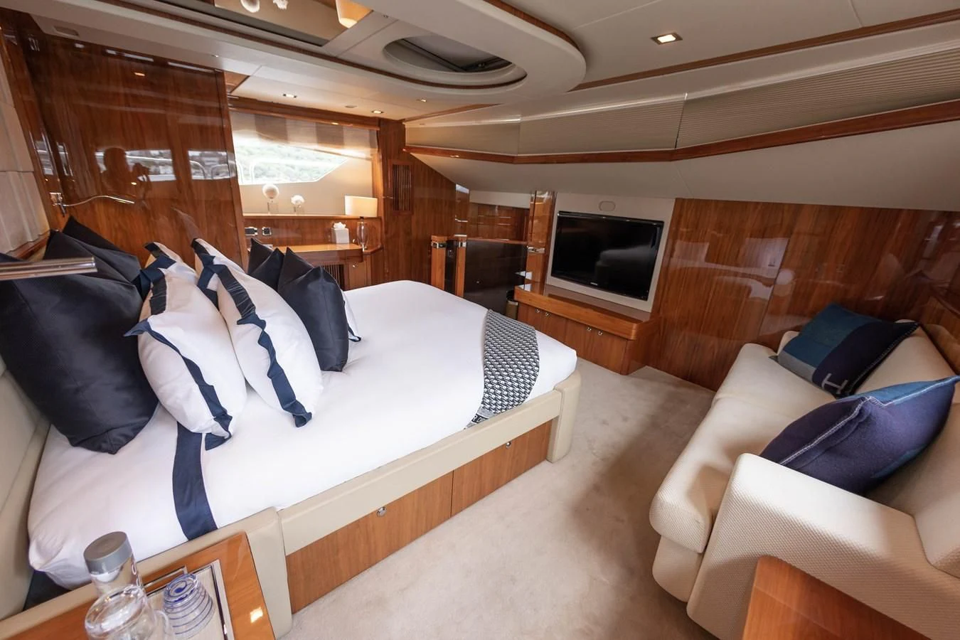 a room with a bed and a couch aboard CHAOS Yacht for Sale
