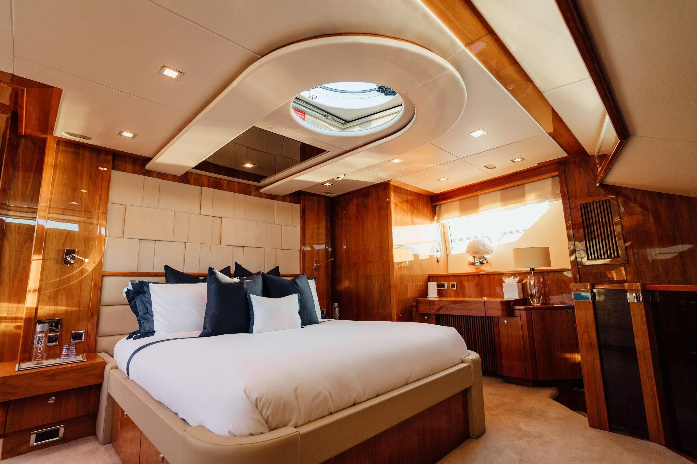 a bedroom with a bed and a wood wall aboard CHAOS Yacht for Sale
