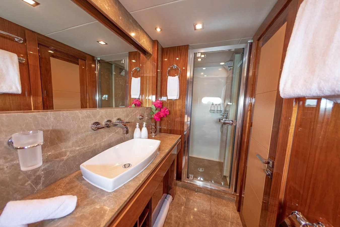 a bathroom with a large mirror aboard CHAOS Yacht for Sale