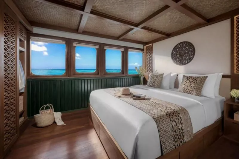 a bedroom with a bed and a large window aboard SAMSARA SAMUDRA Yacht for Sale