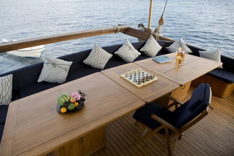 a boat with a table and chairs on it aboard SAMSARA SAMUDRA Yacht for Sale