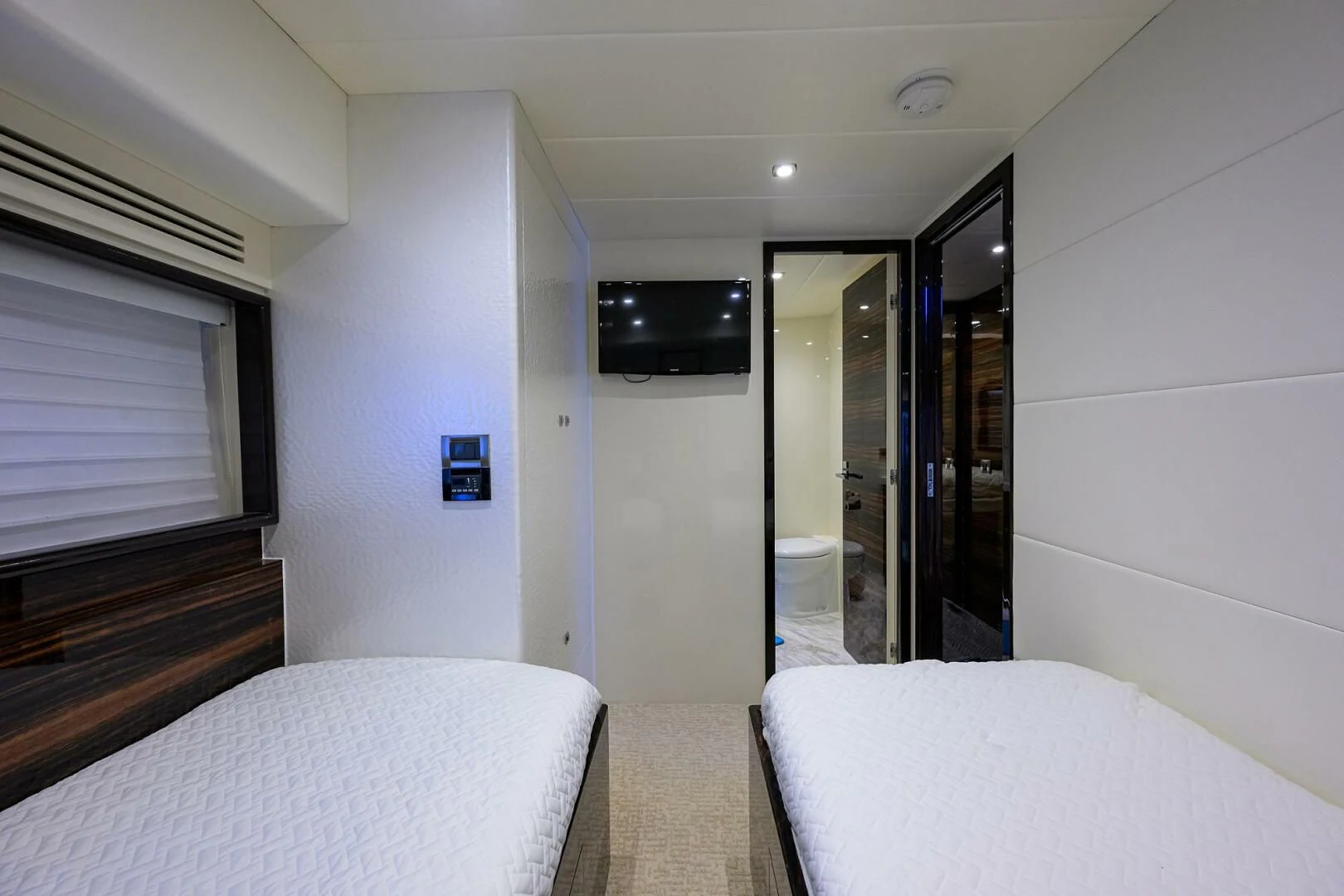a bedroom with a bed and a mirror aboard FUJIMO Yacht for Sale