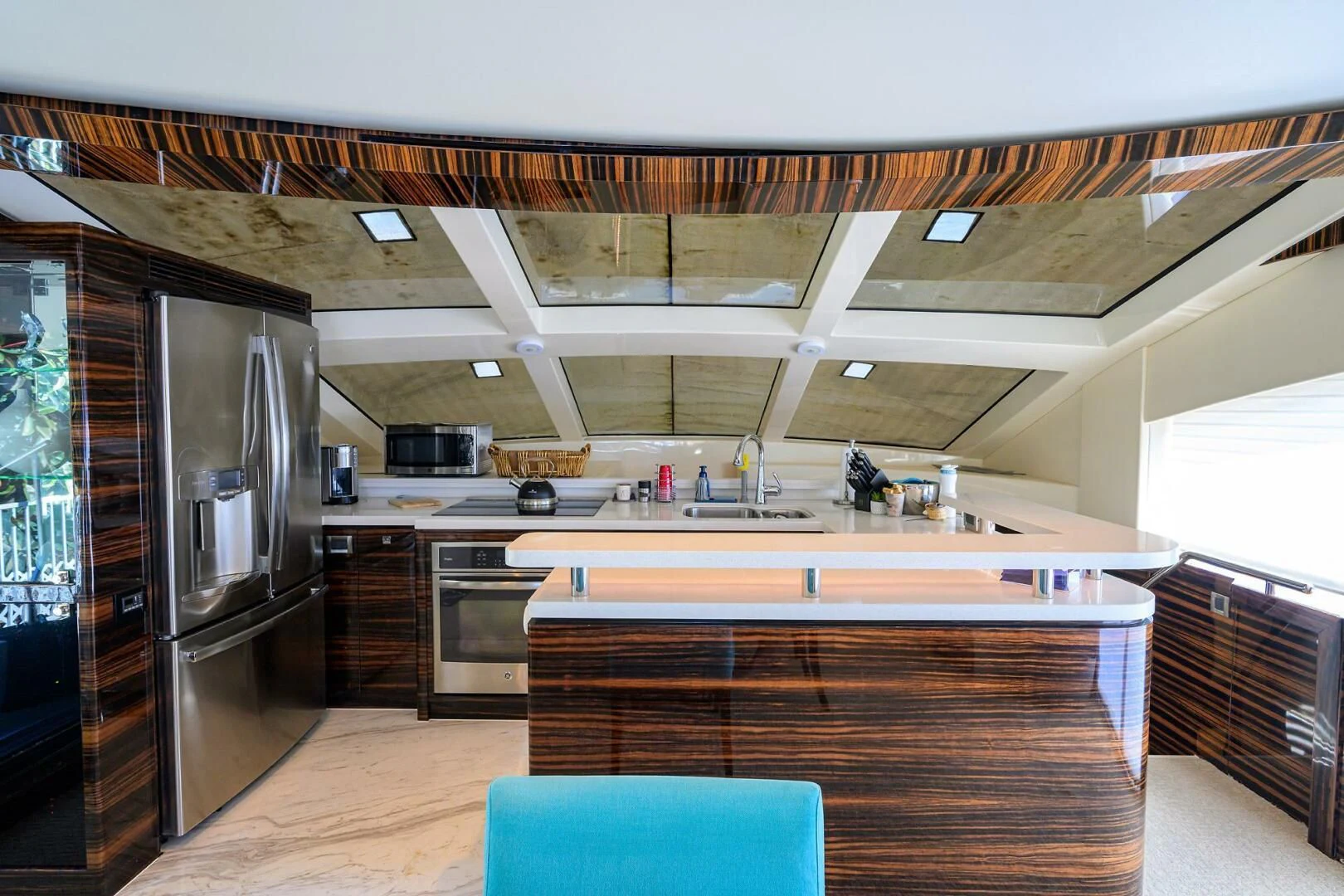 a kitchen with a large refrigerator aboard FUJIMO Yacht for Sale