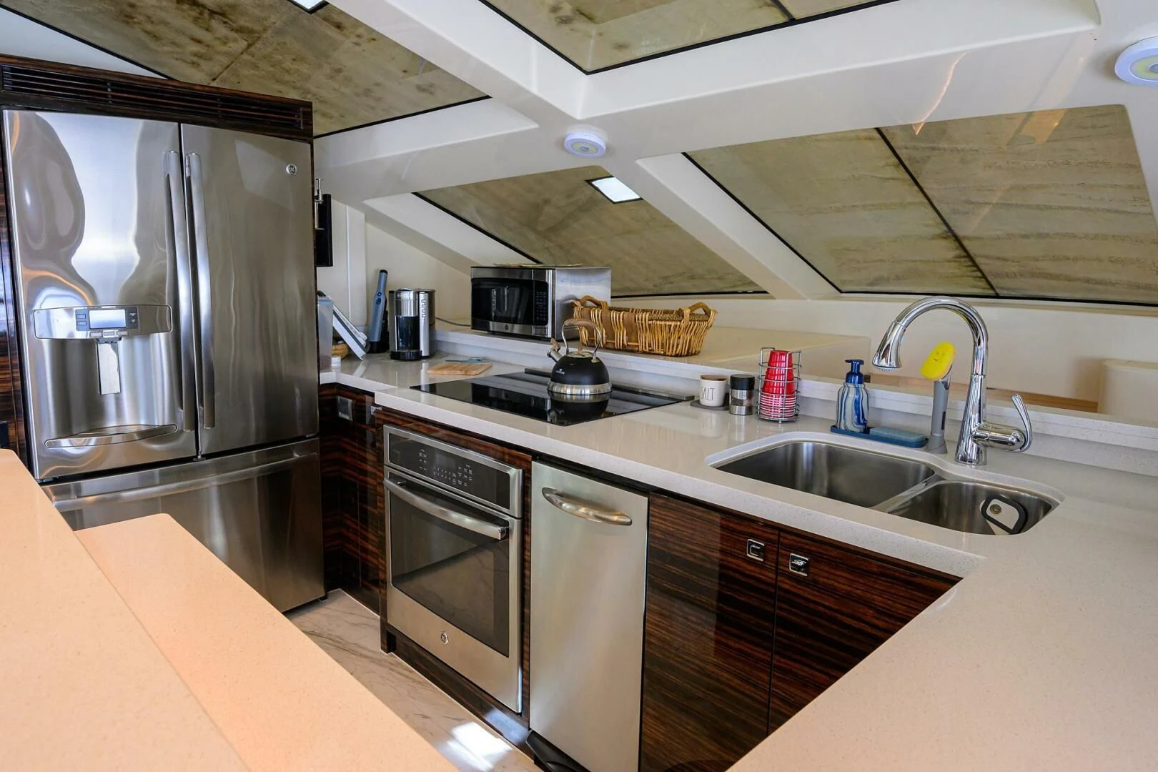 a kitchen with stainless steel appliances aboard FUJIMO Yacht for Sale