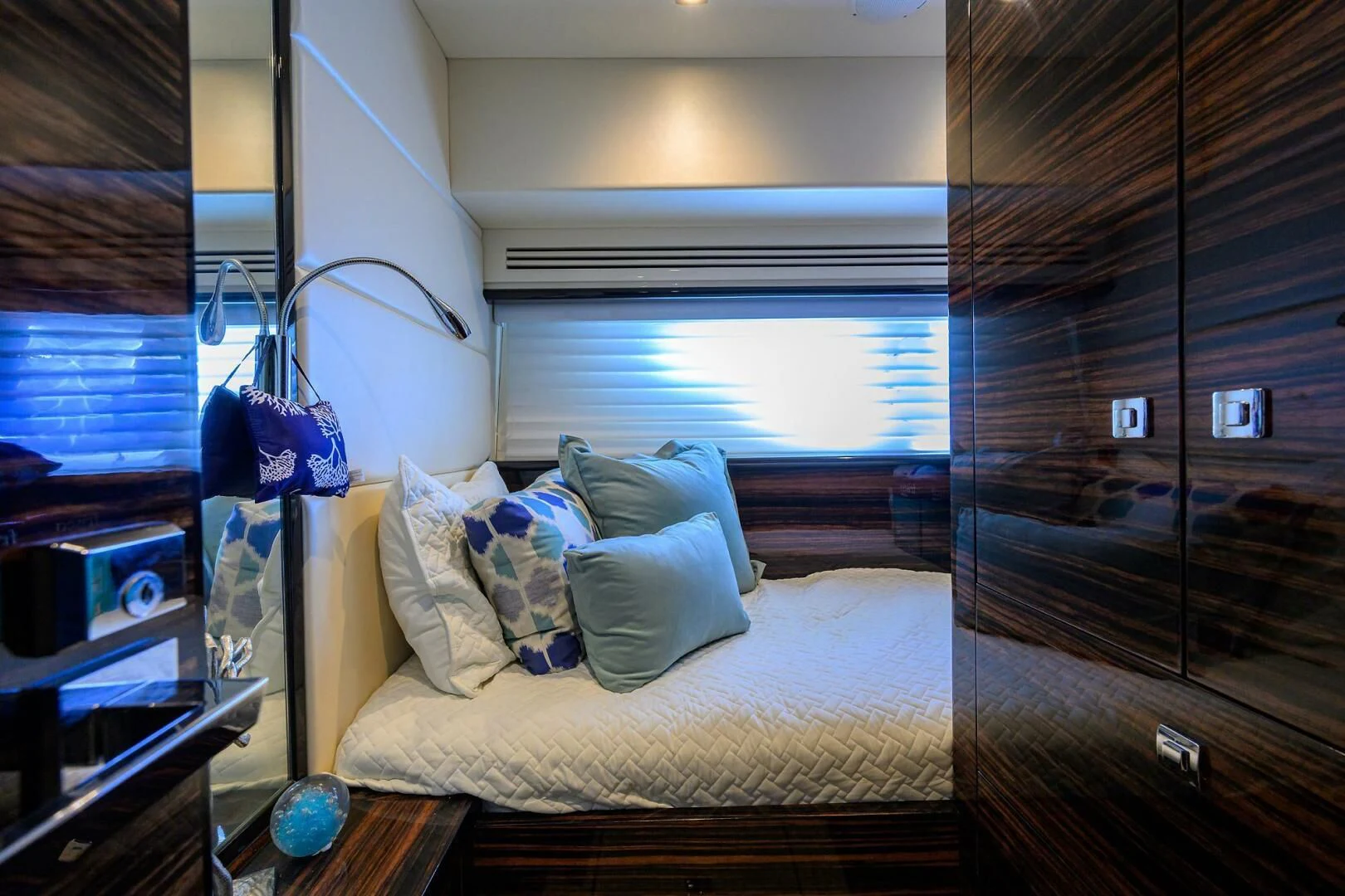 a bedroom with a bed and a window aboard FUJIMO Yacht for Sale