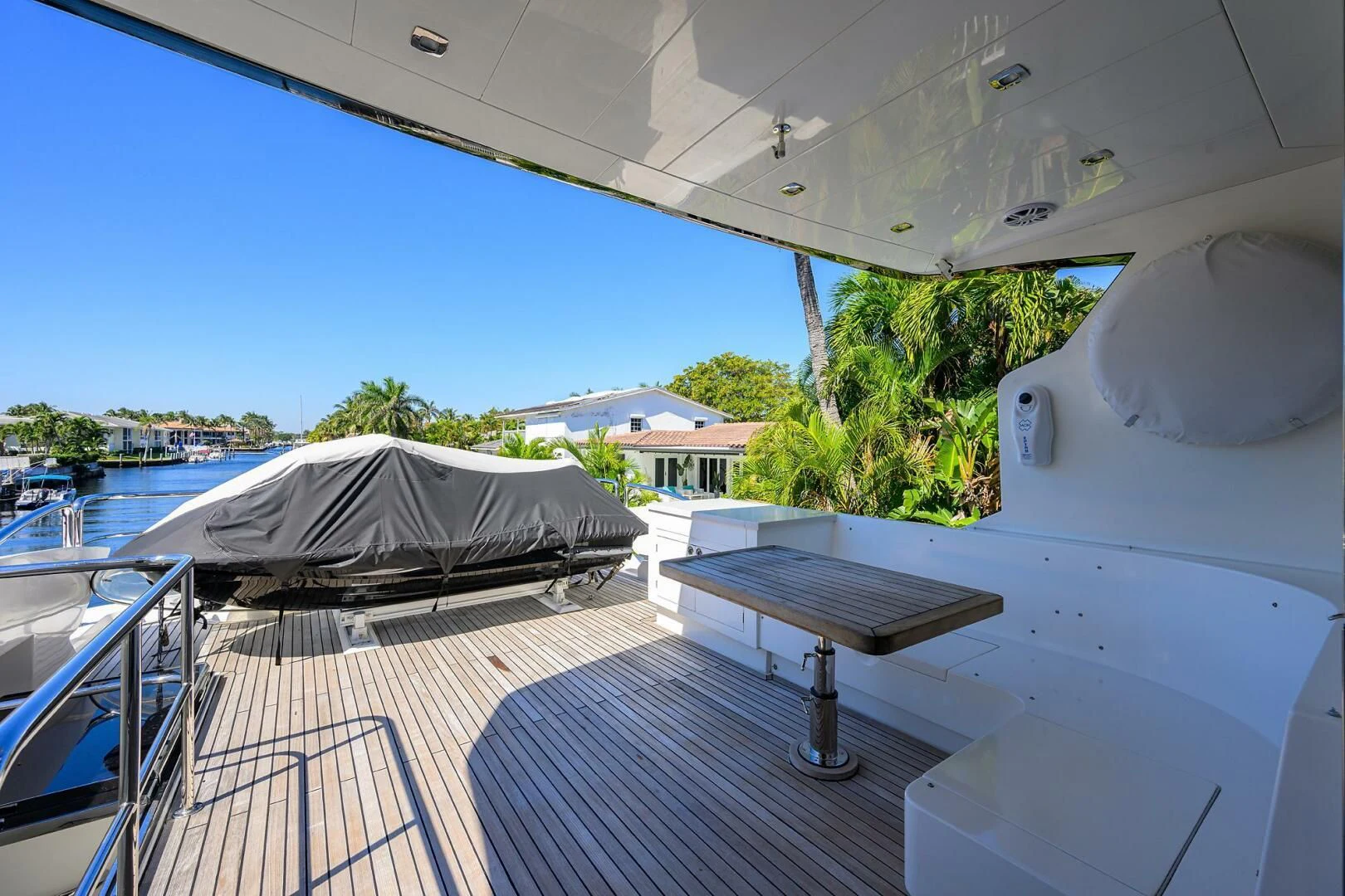a balcony with a table and a bed on it aboard FUJIMO Yacht for Sale