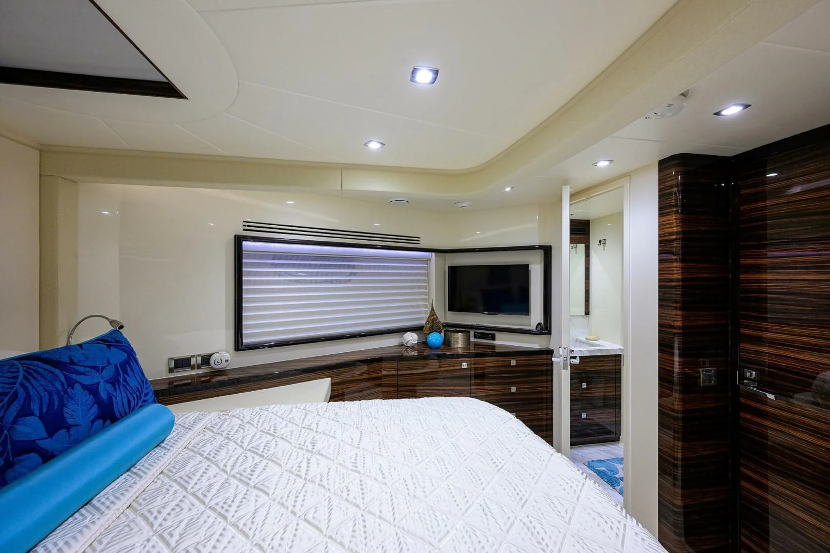 a bedroom with a bed and a television aboard FUJIMO Yacht for Sale