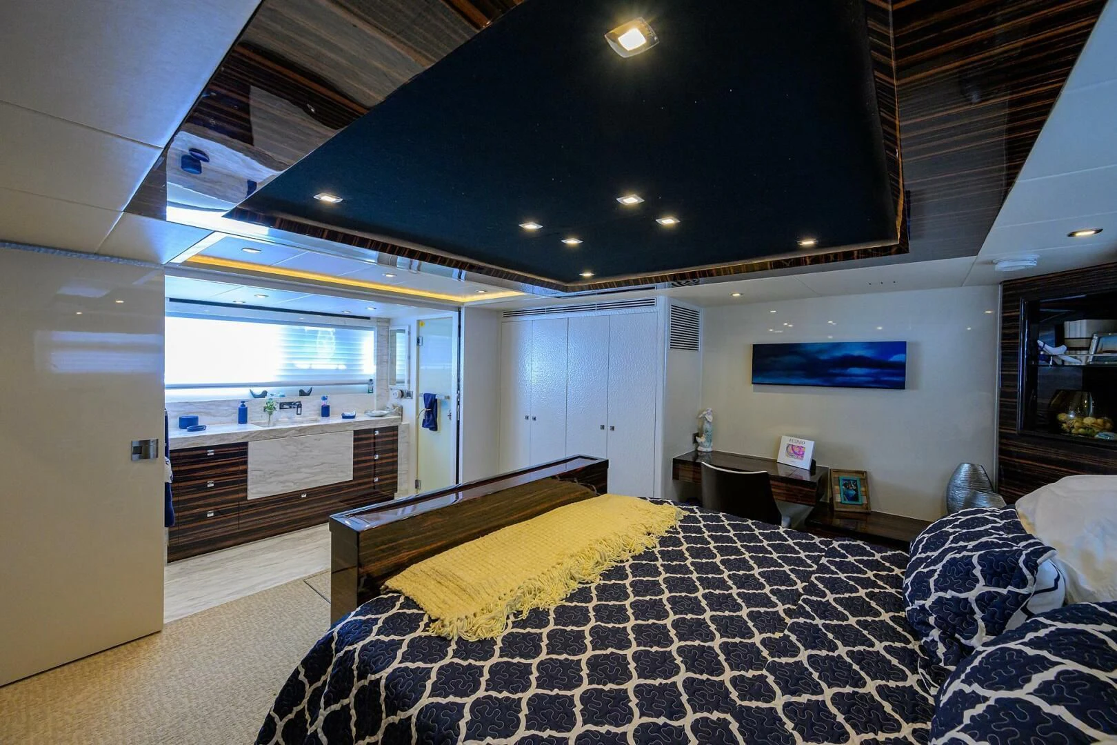 a bedroom with a bed and a large window aboard FUJIMO Yacht for Sale