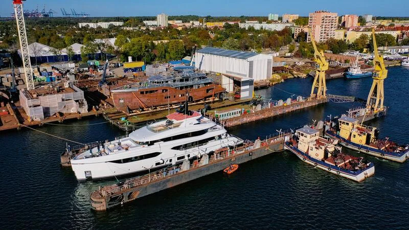 a large ship docked at a port aboard ACE Yacht for Sale