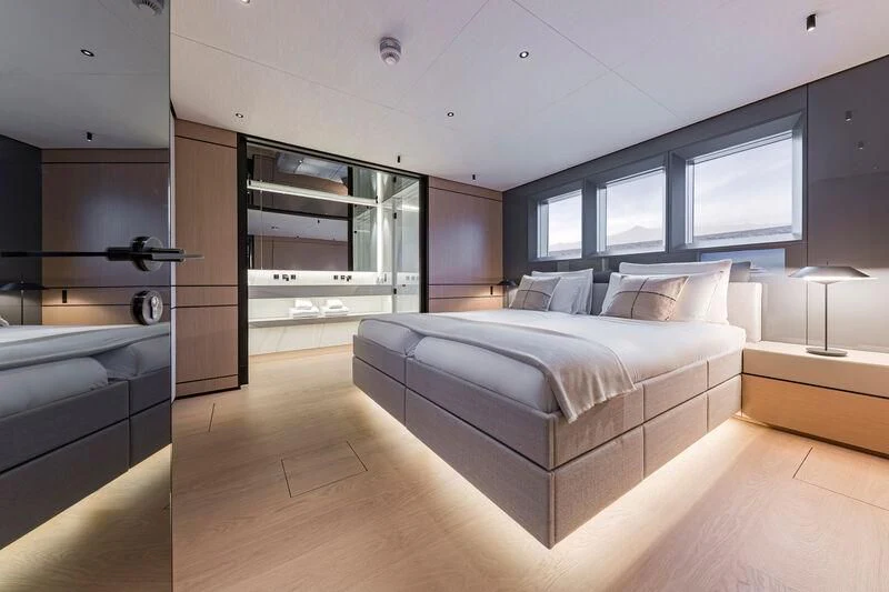 a room with a bed and a desk aboard ACE Yacht for Sale