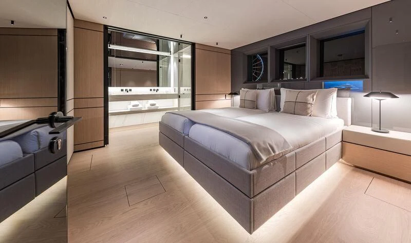 a bedroom with a bed and a desk aboard ACE Yacht for Sale