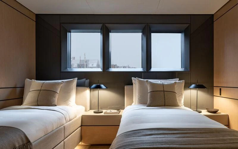 a room with two beds aboard ACE Yacht for Sale