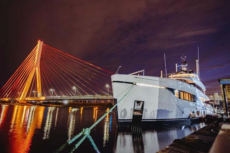a boat docked at night aboard ACE Yacht for Sale