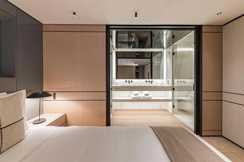 a room with a bed and a glass door aboard ACE Yacht for Sale