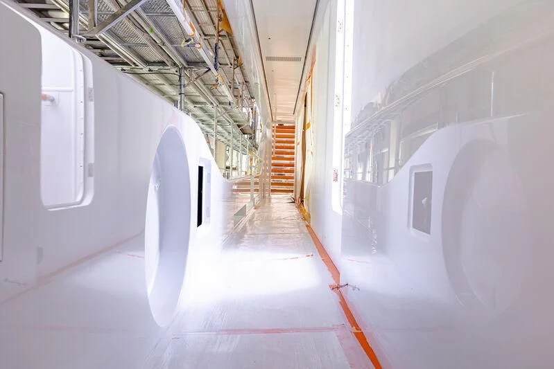 a long hallway with white walls aboard ACE Yacht for Sale