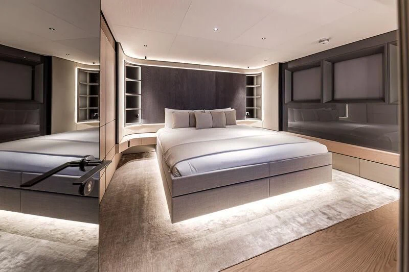a room with a bed and a mirror aboard ACE Yacht for Sale