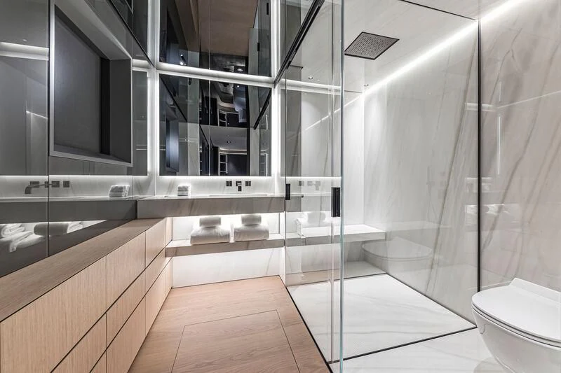 a bathroom with a glass shower aboard ACE Yacht for Sale