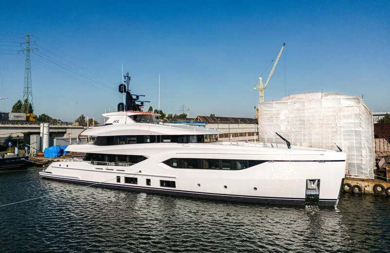 a large white boat in a harbor aboard ACE Yacht for Sale