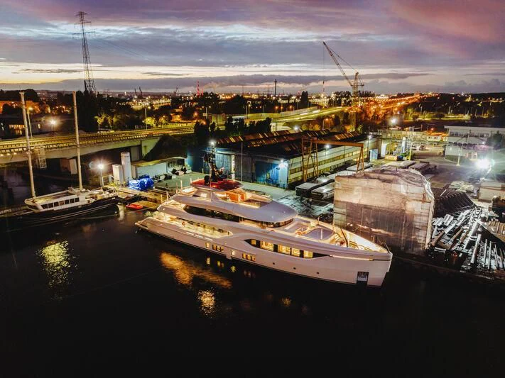 a city with boats at night aboard ACE Yacht for Sale