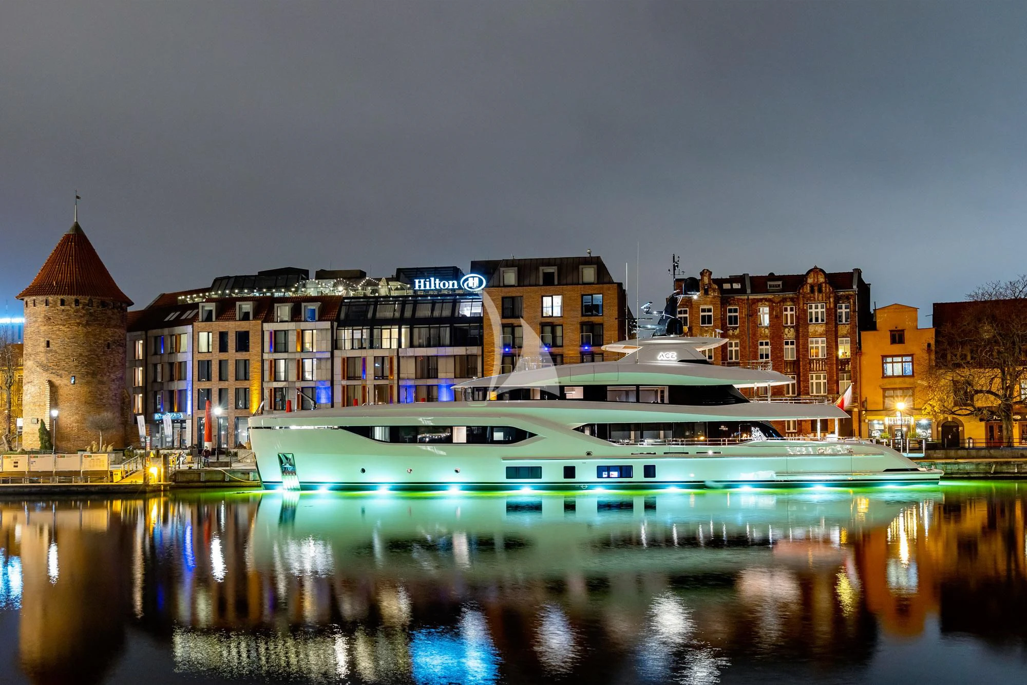 a boat on water in front of buildings aboard ACE Yacht for Sale